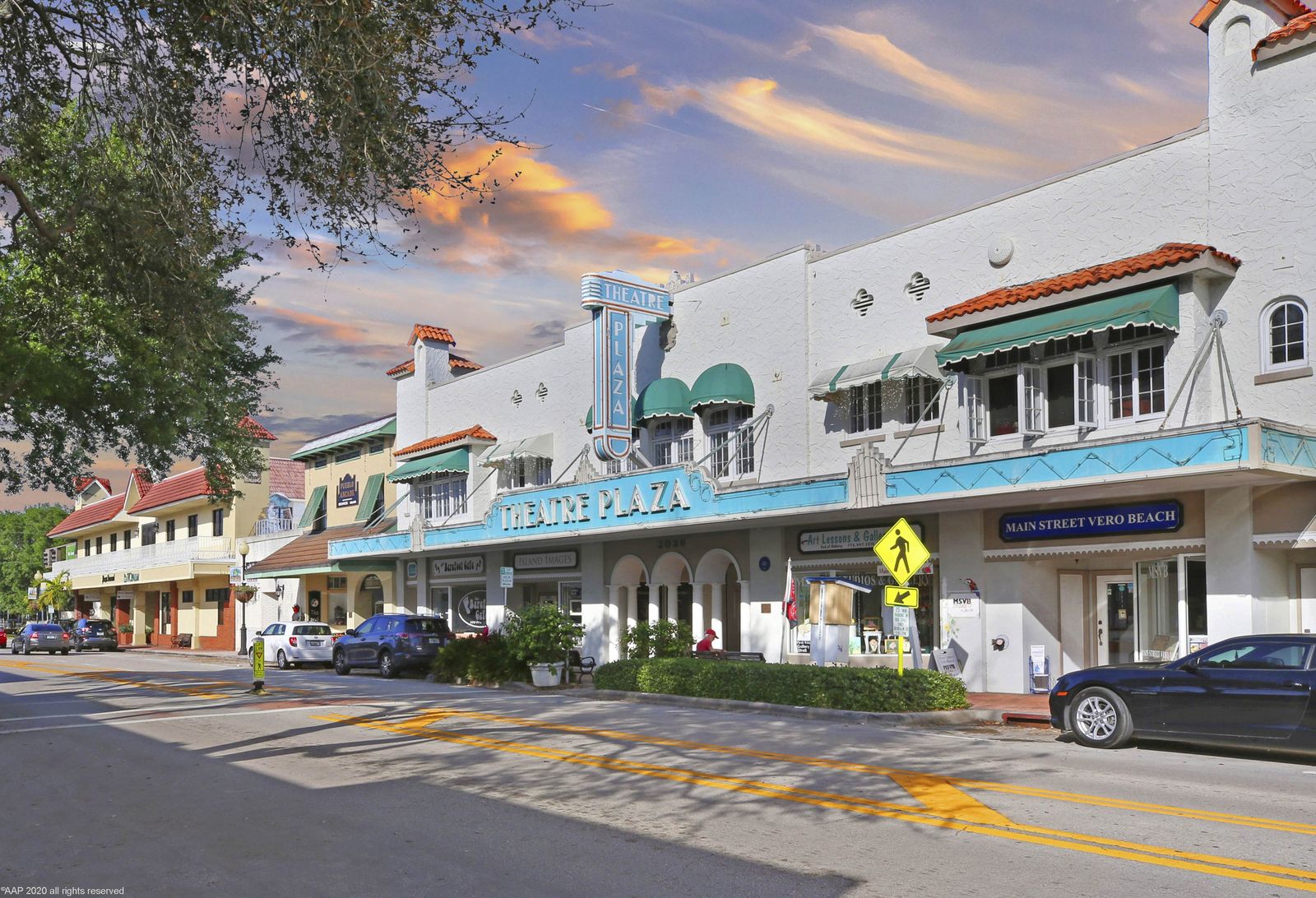 Theatre Plaza building with awnings and storefronts on a downtown Vero Beach street